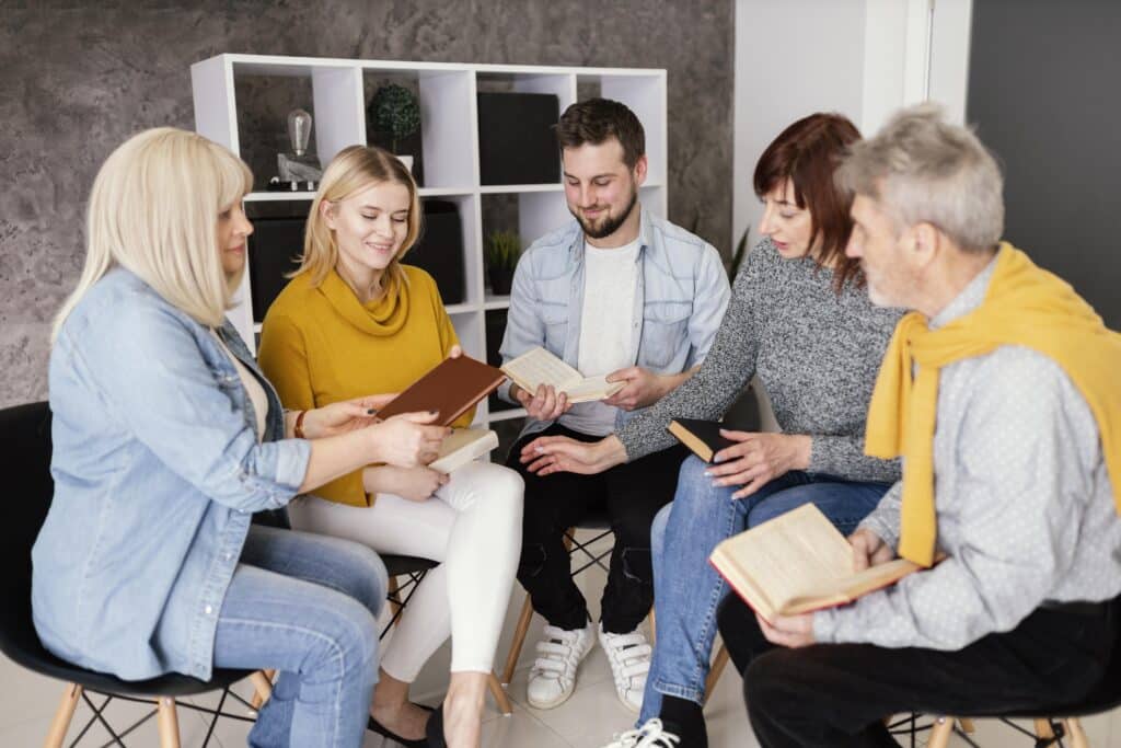 group people reading books therapy session